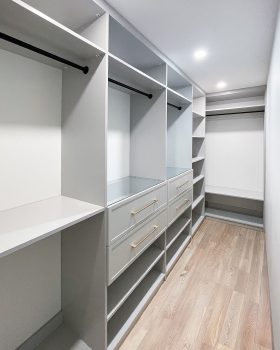 Professional L-shaped walk-in closet installation in Toronto with premium finish