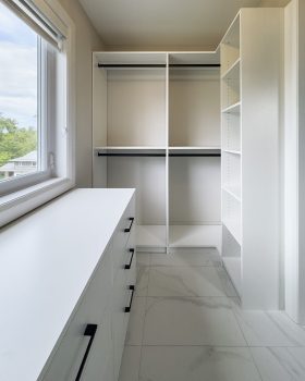 Custom reach-in closet Toronto with white built-in drawers and shelving