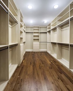 Spacious walk-in closet design Toronto with custom wood laminate shelving