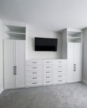 Full wall custom closet unit Toronto featuring integrated TV space and drawers